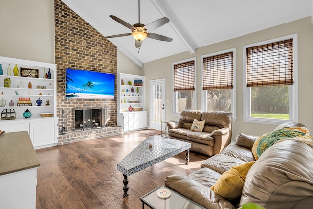 living room with a brick fireplace, ceiling fan, dark hardwood / wood-style floors, built in features, and vaulted ceiling with beams