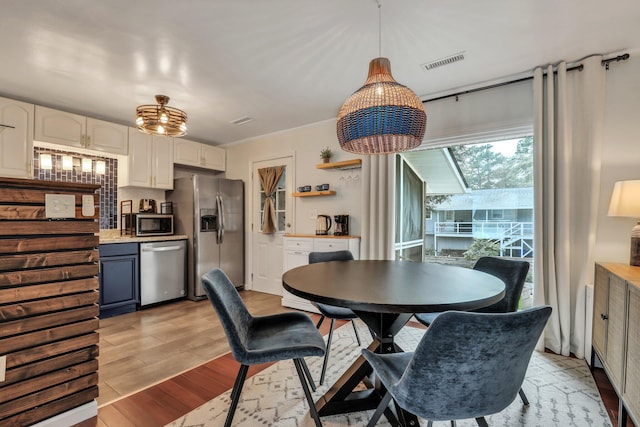 dining space featuring crown molding