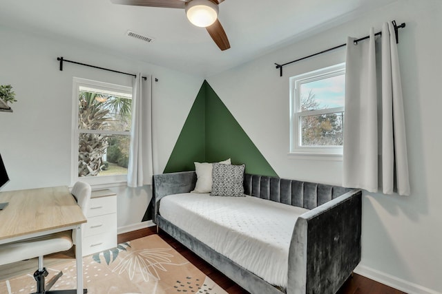 bedroom featuring ceiling fan and dark wood-type flooring