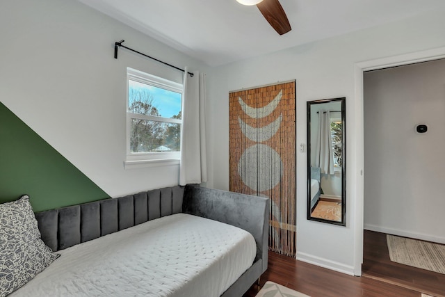 bedroom with ceiling fan and dark wood-type flooring