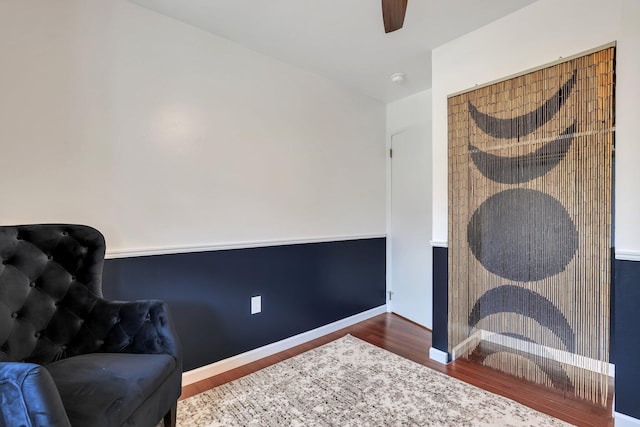 living area with ceiling fan and hardwood / wood-style flooring