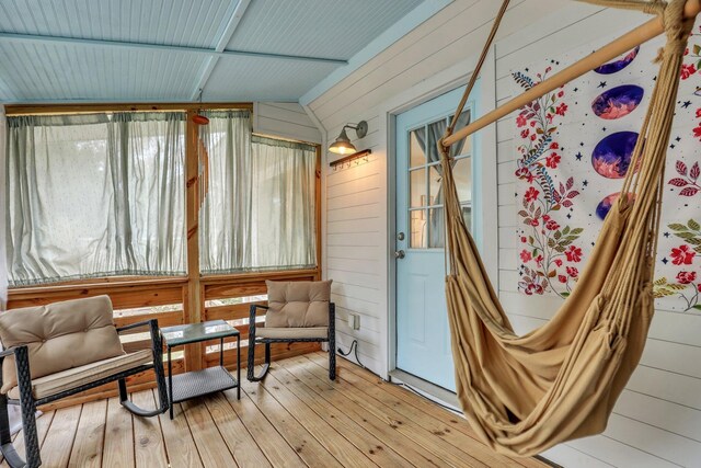 sunroom / solarium featuring lofted ceiling