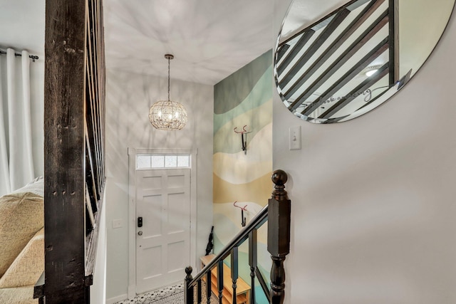 foyer entrance with a notable chandelier