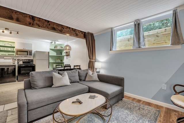 living room with beamed ceiling, wood ceiling, and light hardwood / wood-style flooring