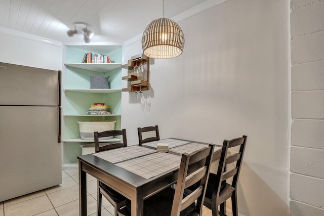 dining area featuring light tile patterned floors and ornamental molding