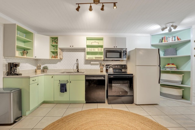 kitchen with tasteful backsplash, sink, black appliances, light tile patterned floors, and green cabinetry