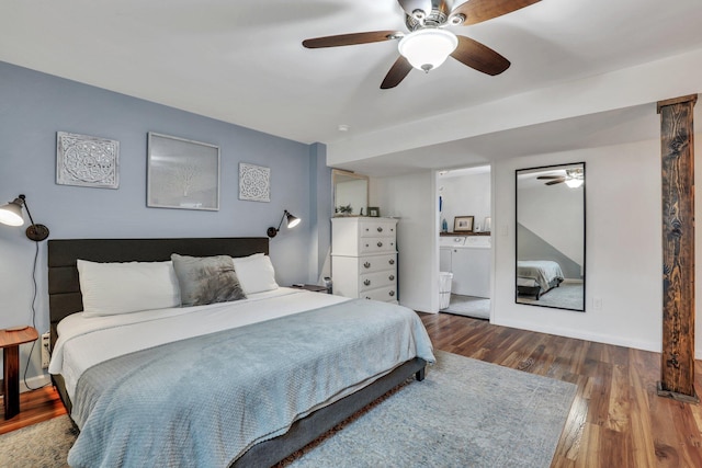 bedroom with wood-type flooring, connected bathroom, washer and clothes dryer, and ceiling fan