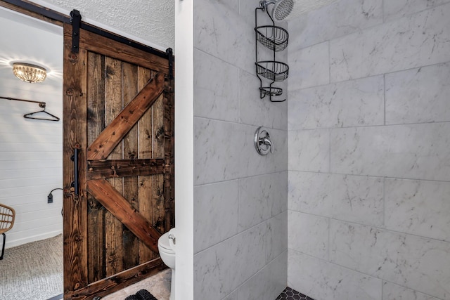 bathroom with tiled shower and toilet