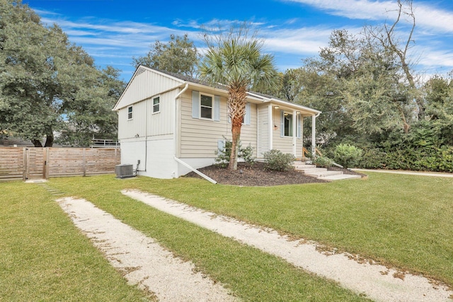 view of front of house featuring a front yard and central air condition unit