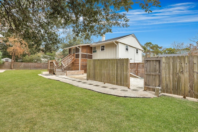 rear view of property with a lawn