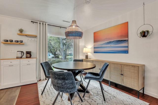 dining space with dark hardwood / wood-style floors