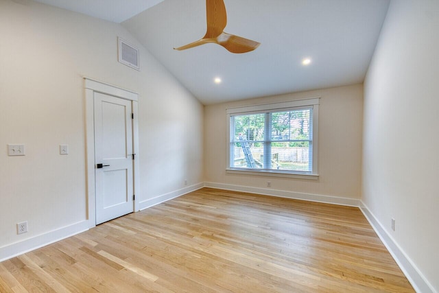 spare room featuring visible vents, baseboards, ceiling fan, lofted ceiling, and light wood-style flooring