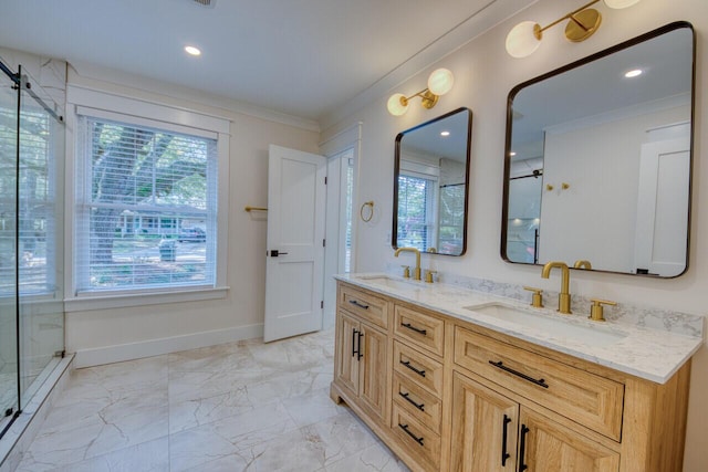 full bath featuring a shower stall, ornamental molding, marble finish floor, and a sink