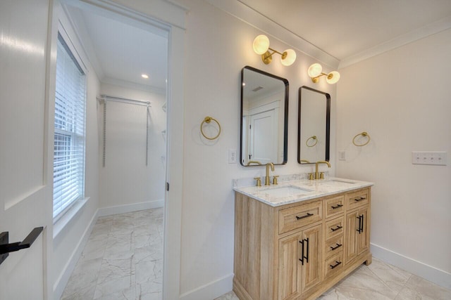 full bathroom with marble finish floor, crown molding, baseboards, and a sink