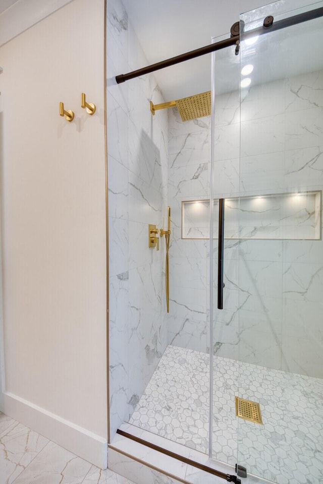 full bathroom with baseboards, marble finish floor, and a marble finish shower