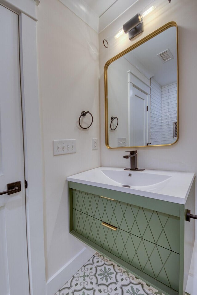 bathroom featuring visible vents, vanity, and baseboards