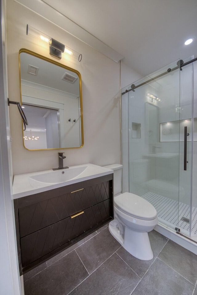 bathroom with vanity, visible vents, a shower stall, tile patterned floors, and toilet