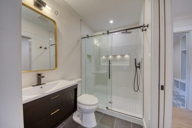 full bathroom featuring tile patterned floors, visible vents, toilet, a stall shower, and vanity