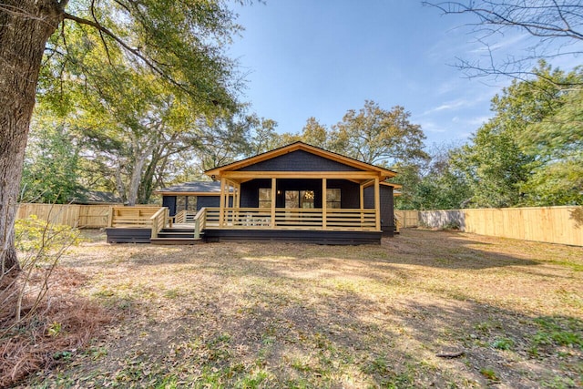 back of property featuring a wooden deck and fence private yard