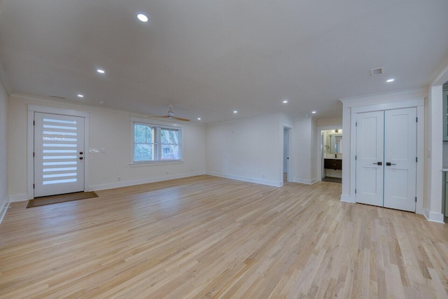 unfurnished living room featuring baseboards, ceiling fan, ornamental molding, recessed lighting, and light wood-style floors