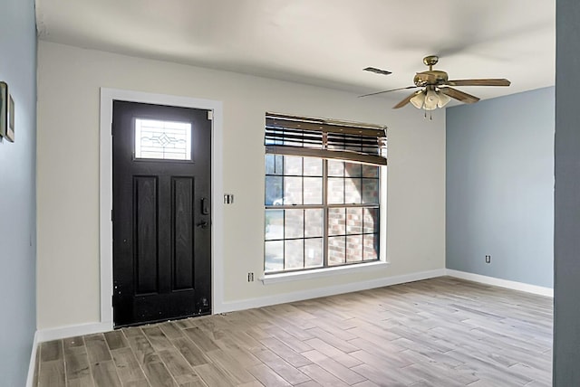 foyer entrance with ceiling fan and light hardwood / wood-style flooring