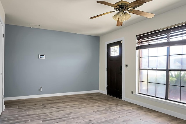 foyer with ceiling fan and light hardwood / wood-style floors