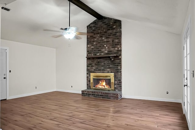 unfurnished living room with vaulted ceiling with beams, ceiling fan, wood-type flooring, and a brick fireplace