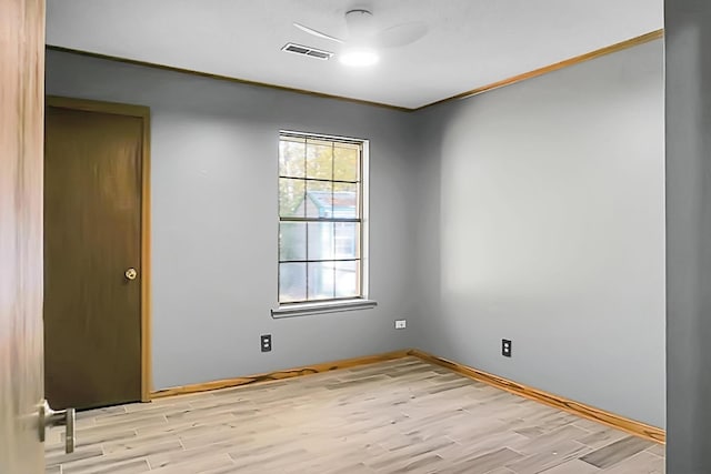 unfurnished room featuring light hardwood / wood-style flooring and ornamental molding