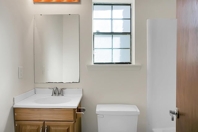 bathroom featuring vanity and toilet