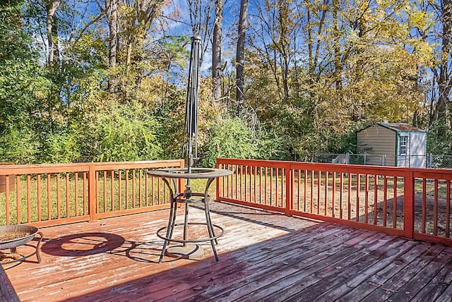 wooden terrace with a storage shed