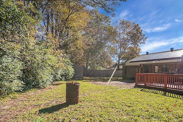 view of yard featuring a storage shed and a deck