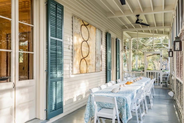 exterior space with beam ceiling and ceiling fan