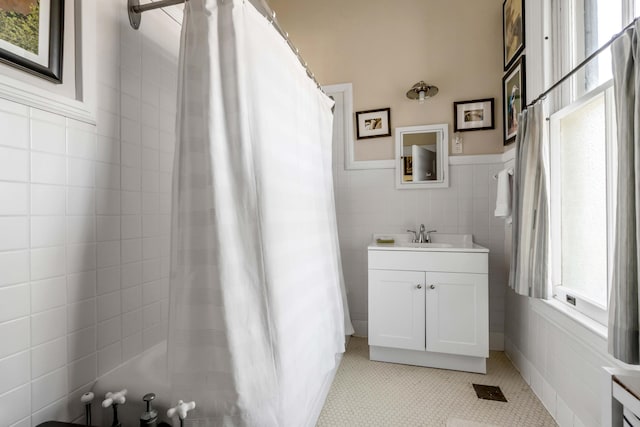 bathroom featuring tile walls, vanity, and a shower with curtain