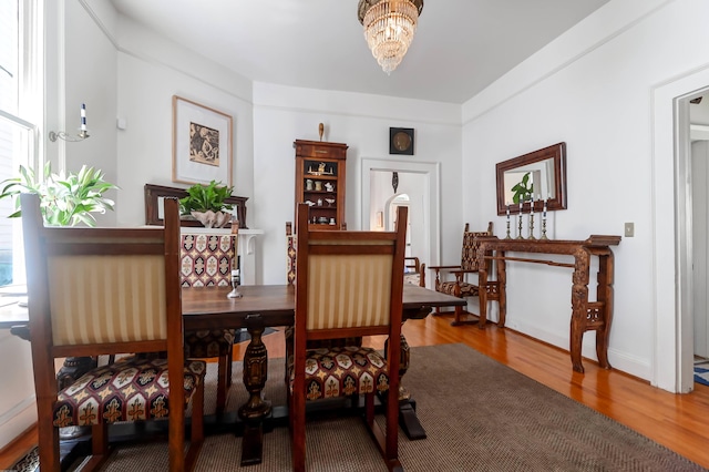 dining room with a notable chandelier and hardwood / wood-style floors