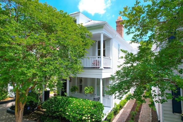 view of side of property with a balcony