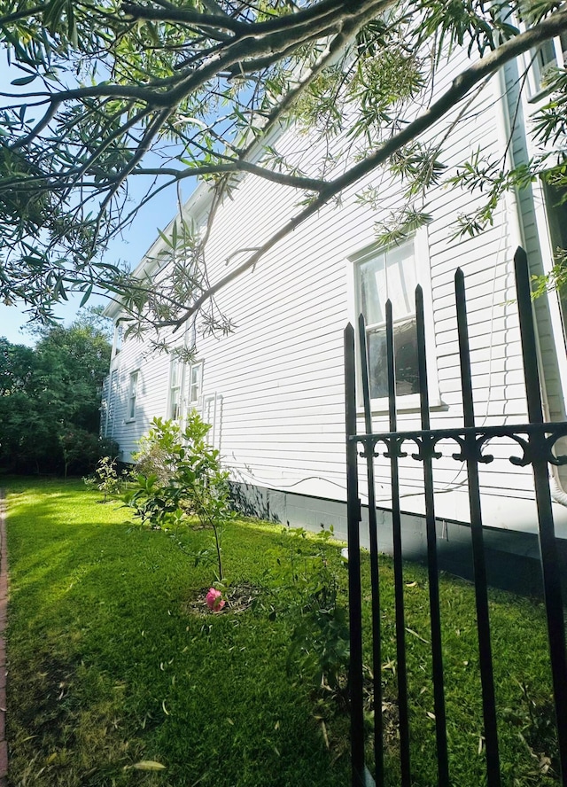 view of home's exterior with a lawn