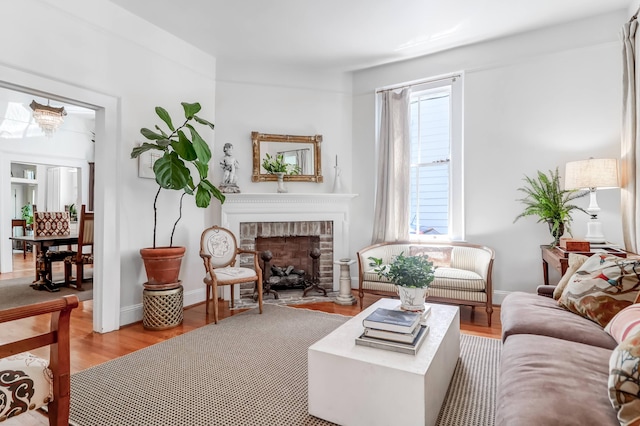 living room featuring hardwood / wood-style floors and a brick fireplace