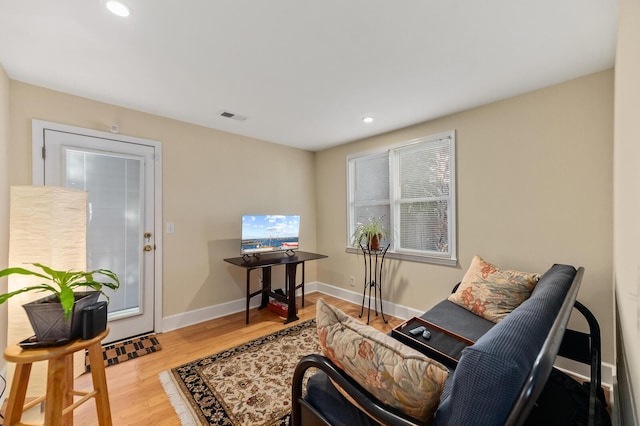 sitting room featuring baseboards, visible vents, wood finished floors, and recessed lighting