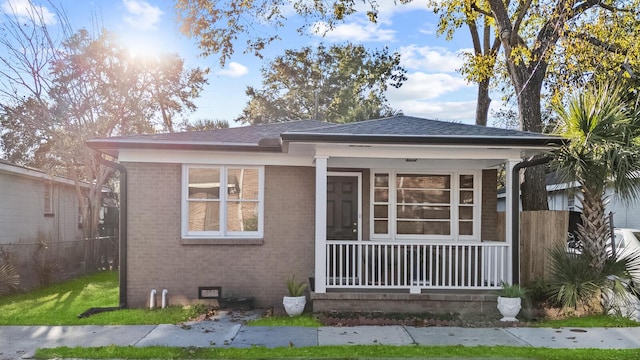 bungalow-style house with crawl space, brick siding, and roof with shingles