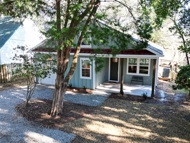 view of front of house with a patio and central AC