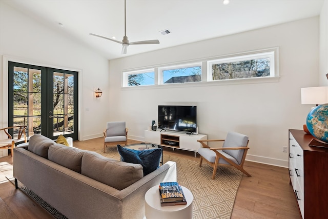 living room featuring french doors, hardwood / wood-style flooring, ceiling fan, and lofted ceiling