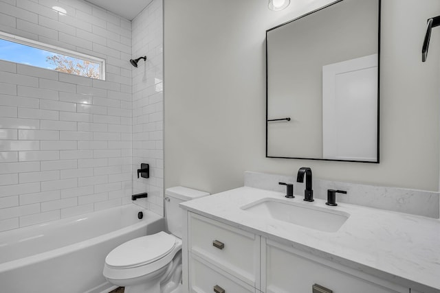 bathroom featuring toilet, washtub / shower combination, and vanity