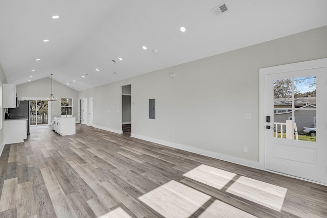 unfurnished living room featuring lofted ceiling, recessed lighting, visible vents, light wood-style floors, and baseboards