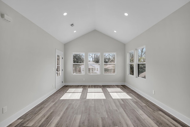 unfurnished room featuring baseboards, visible vents, and light wood-style floors