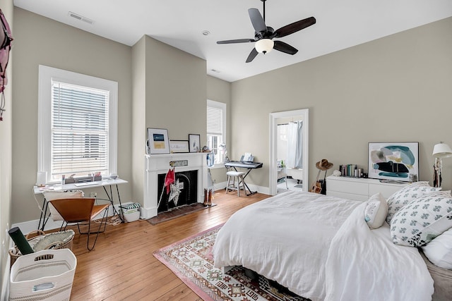 68 Vanderhorst St Unit B, Charleston, SC 29403 - bedroom featuring hardwood / wood-style flooring, multiple windows, and a fireplace