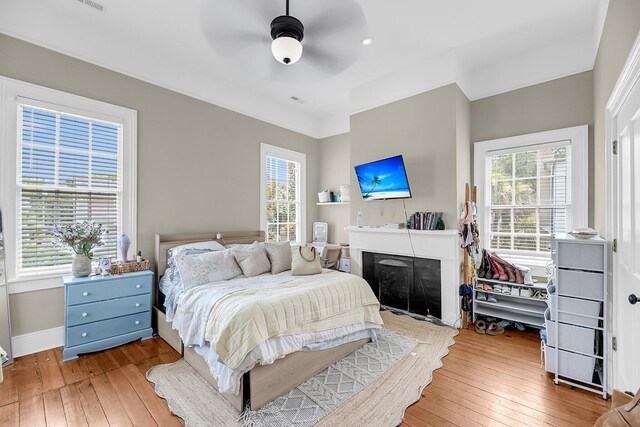 68 Vanderhorst St Unit B, Charleston, SC 29403 - bedroom featuring wood-type flooring, multiple windows, and a fireplace