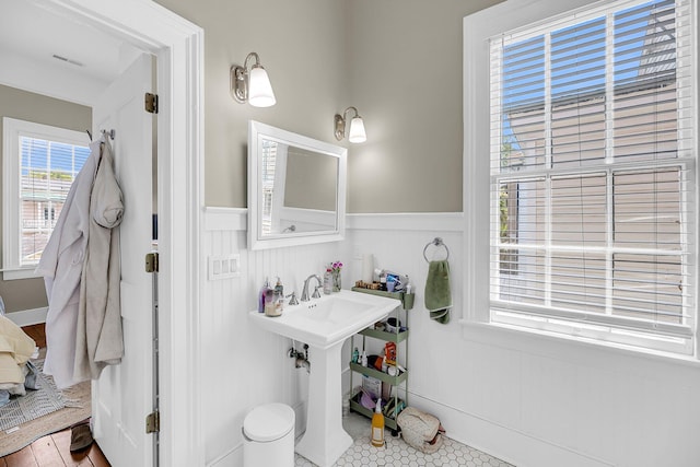 68 Vanderhorst St Unit B, Charleston, SC 29403 - bathroom featuring a wainscoted wall and a decorative wall