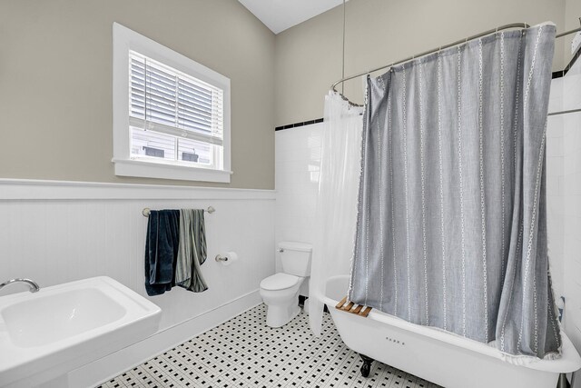 68 Vanderhorst St Unit B, Charleston, SC 29403 - bathroom with a wainscoted wall and shower / bath combo