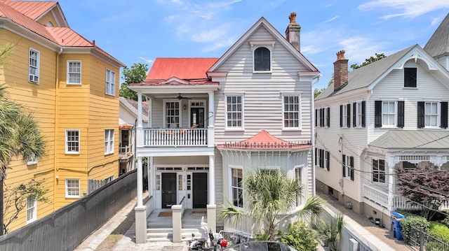 68 Vanderhorst St Unit B, Charleston, SC 29403 - view of front of house with a balcony, a fenced backyard, a metal roof, and a ceiling fan