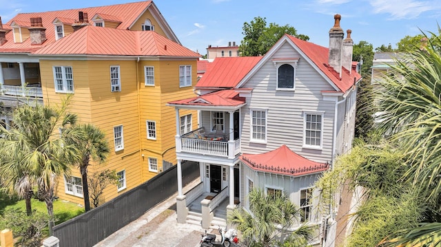 68 Vanderhorst St Unit B, Charleston, SC 29403 - back of property with a balcony, a metal roof, and a chimney